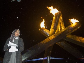 Samaah Jaffer an organizer with the Rally for Humanity, " Love over Fear "  pauses after a moment of silence for the victims of the Quebec City mosque shooting, February 04 2017.  The march included a  lighting of the Olympic flame at the Jack Poole Plaza.