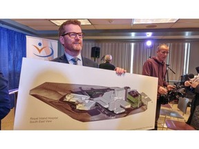 Health Minister Terry Lake with a drawing of what Royal Inland Hospital is expected to look like once the $417-million patient-care tower is built on the east side of the facility.