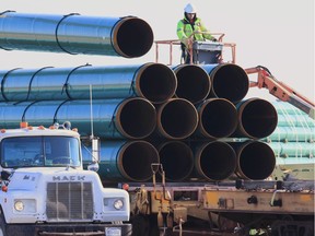 In this May 9, 2015, file photo workers unload pipes for the proposed Dakota Access oil pipeline that would stretch from the Bakken oil fields in North Dakota to Illinois.