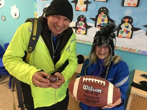 Lorne Terichow of Peninsula Runners and Pam Borlinha of Langley's Sun Run InTraining clinic, ham it up for photos Saturday morning inside W.C. Blair Rec Centre after taking a pass on running outside.