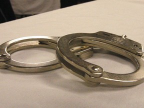 Handcuffs used on men arrested for prostitution solicitation sit on a table at a hotel in Minot, N.D., on Saturday, Jan. 31, 2015. Sex trafficking has become a big problem in North Dakota amid an oil boom that has brought in money and oil workers. The Minot police sting ended with the arrests of 13 men, who answered ads on an escort website posted by the undercover officers.