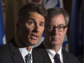 Vancouver Mayor Gregor Robertson speaks about the opioid crisis during a news conference at the Federation of Canadian Municipalities meetings in Ottawa on Jan. 20, as Ottawa Mayor Jim Watson listens.