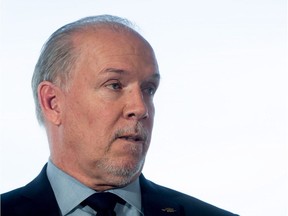 British Columbia NDP leader John Horgan listens to a question after releasing the party's climate plan in Vancouver on Thursday.