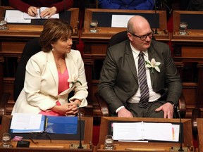 B.C. Premier Christy Clark and her finance minister, Mike de Jong, listen to last week’s throne speech in the Victoria legislature. Will they use this coming week’s budget to introduce tax cuts that include the supposedly revenue-neutral carbon tax?