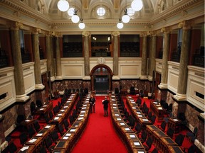 Chamber staff put the orders of the day on the desk of cabinet members before the B.C. Finance Minister Michael de Jong delivers a balanced budget for a fifth year in a row at Legislative Assembly in Victoria, B.C. Tuesday, February 21, 2017.