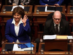 Premier Christy Clark waves to a person as B.C. Finance Minister Michael de Jong waits to deliver a balanced budget for a fifth year in a row at Legislative Assembly in Victoria, B.C. Tuesday, February 21, 2017.