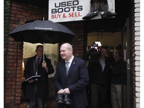 B.C. Finance Minister Michael de Jong leaves Olde Town Shoe Repair last year after picking up his budget shoes.