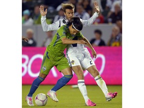 The Whitecaps have acquired Fredy Montero. Seattle Sounders FC forward Montero, left, and Los Angeles Galaxy midfielder David Beckham battle for the ball during the first half of their MLS soccer match, Sunday, Oct. 28, 2012, in Carson, Calif.