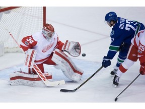 Red Wings goalie Petr Mrazek makes a glove save on Ben Hutton.