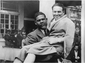 A young Joe Louis carries Jimmy McLarnin.