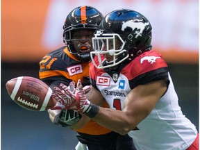 B.C. Lions' Ryan Phillips, back, knocks down a pass intended for Calgary Stampeders' Lemar Durant during the first half of a CFL football game in Vancouver, B.C., on Saturday June 25, 2016.