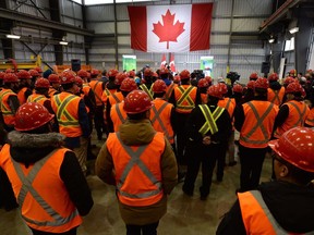 Shipyard workers listen as Public Services Minister Judy Foote and Defence Minister Harjit Sajjan make an announcement about shipbuilding in Canada, in Vancouver on Tuesday, February 28, 2017.