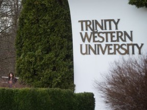 A student leaves Trinity Western University in Langley, B.C., on Wednesday, February 22, 2017.