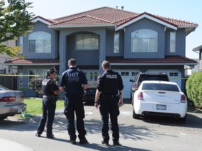 The Integrated Homicide Investigation Team probes the scene of a fatal shooting in the 14300-block 90A Avenue in Surrey on July 24, 2016. Nick Procaylo/PNG files