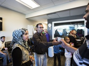 Bassam SuaIfan serving tea with his daughter, Mariana at the Refugee and Immigrant Welcome Centre in Surrey, B.C. Bassam SuaIfan is a volunteer at the centre.