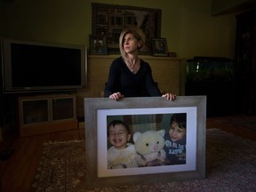 Tim Kurdi sits for a photograph with a photo of her late nephews Alan, left, and Ghalib Kurdi at her home in Coquitlam, B.C., on Monday August 22, 2016. The young Syrian boys and their mother died last year after the small rubber boat they were in capsized during a desperate voyage from Turkey to Greece.