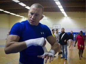 UFC welterweight champion Georges St-Pierre takes part in a training session on Nov. 7, 2011 in Issy-les-Moulineaux, a Paris suburb. His return to action has been met with more grumbling than you'd expect.