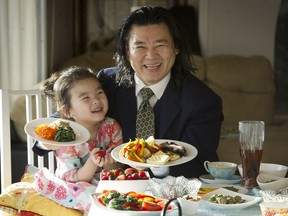 Dr. Albert Kim, with his daughter Pearl, shows off some vegetarian choices. He began his meat-free life in 1998, when he spent six months in a Taiwanese monastery.