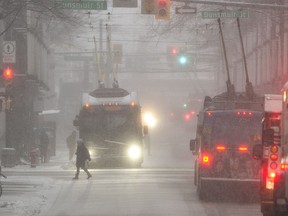 Heavy blowing  snow covered commuters and pedestrians making their way across Granville street in downtown Vancouver on February 6, 2017.