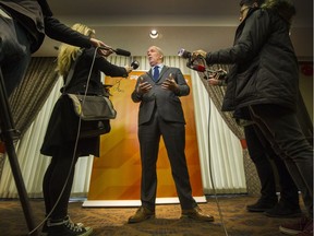 B.C. NDP leader John Horgan talks to reporters after the party council meeting in Vancouver on Feb. 25.