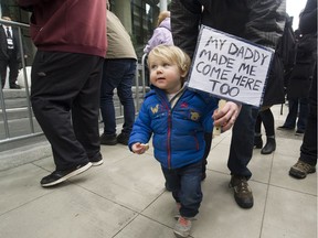 Hundreds protest, including 1 and a half year old Lucas, outside the official opening of the Trump Tower in Vancouver, BC. February 28, 2017.  (Arlen Redekop / PNG staff photo) (story by Nick Eagland) [PNG Merlin Archive]