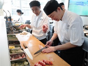 Fairmont Pacific Rim chef Takayuki Omi, right, works on a gozen lunch.