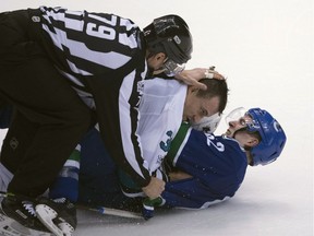 Joseph LaBate goes to the ice with Micheal Haley during second period NHL action.