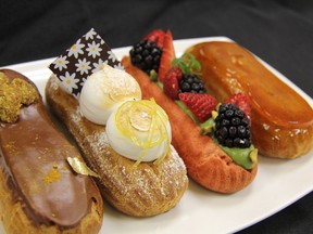 Eclairs from the pastry class at Vancouver Pastry School, from left, chocolate, with curry crumble; lemon kalamansi, with ginger custard with honey meringues; red eclair shell with pistachio cream and fresh berries; and coffee and caramel.