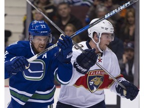 Vancouver Canucks forward Daniel Sedin battles with Mark Pysyk of the Florida Panthers in NHL action last month at Rogers Arena. Sedin has been battling to get on the scoreboard for the past 20 games, too.