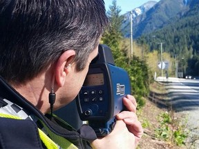 A West Vancouver police officer conducts a radar check. A driver and his passenger were ticketed after a dangerous, high-speed attempt to film their escapades on Highway 99 on Monday.