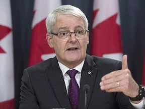 Minister of Transport Marc Garneau speaks at a news conference in Ottawa, Thursday, February 23, 2017. Garneau is proposing the creation of a tough national standard to penalize distracted drivers using their cellphones on the road. THE CANADIAN PRESS/Adrian Wyld