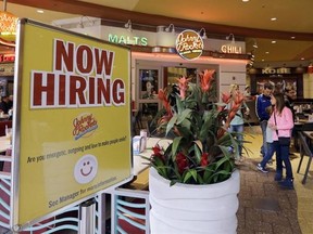 FILE - In this Feb. 9, 2016 file photo, a restaurant posts a sign indicating they are hiring, in Miami. The Labor Department says unemployment claims dropped by 19,000 from 242,000 the previous week, Thursday, March 2, 2017, to the lowest level since March 1973 when President Richard Nixon was in the White House. The less volatile four-week average fell by 6,250 to 234,250, lowest since April 1973. (AP Photo/Alan Diaz, File)