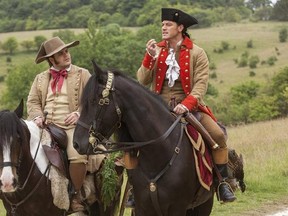 This image released by Disney shows Josh Gad as Le Fou, left, and Luke Evans as Gaston in a scene from, &ampquot;Beauty and the Beast,&ampquot; opening nationwide on March 17. (Laurie Sparham/Disney via AP)