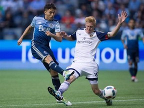 Vancouver Whitecaps&#039; Nicolas Mezquida, left, takes a shot on goal as Real Salt Lake&#039;s Justen Glad defends during the second half of an MLS soccer game in Vancouver, B.C., on Wednesday July 13, 2016. The Whitecaps have re-signed attacking midfielder Mezquida to a new contract through 2018, with a club option for 2019. THE CANADIAN PRESS/Darryl Dyck