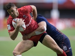 Canada&#039;s Justin Douglas, front, is tackled by Scotland&#039;s Jamie Farndale during World Rugby Sevens Series action, in Vancouver, B.C., on Saturday March 11, 2017. THE CANADIAN PRESS/Darryl Dyck