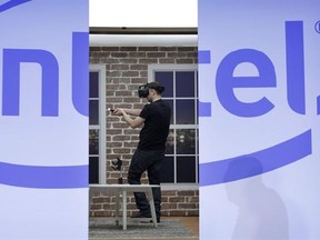 FILE - In this Wednesday, Jan. 4, 2017, file photo, a model demonstrates a Project Alloy all-in-one merged reality headset during an Intel news conference before CES International, in Las Vegas. Intel is buying Mobileye in a deal announced Monday, March 13, 2017 and valued at about $14.09 billion, the latest push by a major tech company into autonomous vehicles that could change the way traffic moves globally. (AP Photo/John Locher, File)