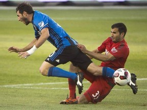 Toronto FC defender Steven Beitashour (33) trips up Montreal Impact midfielder Ignacio Piatti (10) during first half Canadian Championship soccer action in Toronto in a June 1, 2016, file photo. Beitashour is still paying the price for a ball to the head last season which left him with a concussion, one that he&#039;s still dealing with. THE CANADIAN PRESS/Nathan Denette