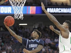 Rhode Island guard Jarvis Garrett, left, goes to the basket against Oregon forward Jordan Bell during the first half of a second-round game of the NCAA men&#039;s college basketball tournament in Sacramento, Calif., Sunday, March 19, 2017. (AP Photo/Steve Yeater)
