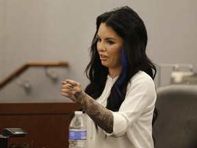 FILE - In this Nov. 14, 2014, file photo, Christine Mackinday, also known as Christy Mack, points toward Jonathan Paul Koppenhaver, also known as War Machine, during a preliminary hearing for Koppenhaver in Las Vegas, Nev. A jury is deliberating whether the former mixed martial arts fighter, Koppenhaver also named War Machine is guilty of charges that could get him life in prison in an attack on his porn star ex-girlfriend Mackinday, and her male friend in August 2015. (AP Photo/John Locher, fil