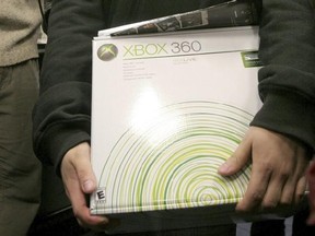 FILE - In this Nov. 22, 2005 file photo, an XBox 360 is purchased in New York. The Supreme Court suggested Tuesday, March 21, 2017, that it is sympathetic to Microsoft Corp. in a dispute with disgruntled owners of the Xbox 360 video-game system who sued saying the console has a design defect that scratches game discs. (AP Photo/Tina Fineberg, File)