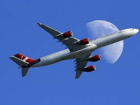FILE - In this Sunday, Aug. 23, 2015, file photo, a Virgin Atlantic passenger plane crosses a waxing gibbous moon on its way to the Los Angeles International Airport, in Whittier, Calif. Alaska said Wednesday, March 22, 2017, that it will retire the Virgin brand, probably in 2019. Alaska announced in 2016, that it was buying Virgin, but CEO Brad Tilden held out hope to Virgin fans that he might keep the Virgin America brand, and run it and Alaska as separate airlines under the same corporate umb