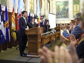 Prime Minister Justin Trudeau receives a standing ovation at the National Caucus meeting on Parliament Hill in Ottawa on Friday, March 24, 2017. THE CANADIAN PRESS/Justin Tang