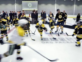 Youth hockey players take the ice after the ceremonial opening of Warrior Ice Arena, the new practice facility for the Boston Bruins NHL hockey team, Thursday, Sept. 8, 2016, in Boston. Hockey Canada says it will make it mandatory that children getting their first introduction to the game play on reduced-size ice surfaces instead of full-sized rinks. THE CANADIAN PRESS/AP/Elise Amendola