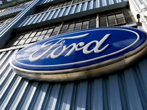 FILE - This Thursday, Nov. 19, 2015, file photo, shows a blue oval Ford sign above the entrance to Butler County Ford in Butler, Pa. Ford is recalling more than 440,000 vehicles in North America to fix problems that can cause engine fires and doors to open unexpectedly. The first recall covers about 230,000 Escape SUVs, Fiesta ST subcompacts, Fusion midsize cars and Transit Connect vans with 1.6-Liter turbocharged engines from 2013 through 2015. The company also is adding 211,000 vehicles to a p