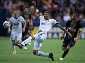 Vancouver Whitecaps&#039; Christian Dean, centre, kicks the ball away from Philadelphia Union&#039;s Alejandro Bedoya, right, during the first half of an MLS soccer game in Vancouver, B.C., on Sunday March 5, 2017. The Vancouver Whitecaps feel pretty good about how things have gone so far in 2017, when they have a full compliment of players on the pitch. THE CANADIAN PRESS/Darryl Dyck