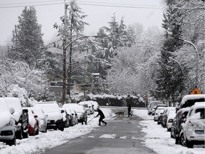 Residents clear snow in the Capitol Hill area of Burnaby on March 5, 2017.