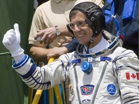 Robert Thirsk gives a thumbs up before entering a spacecraft at the Baikonur Cosmodrome on May 27, 2009. The rocket carried him to the International Space Station, where he spent 188 days.