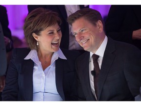 British Columbia Premier Christy Clark, left, and Telus Corp. President and CEO Darren Entwistle share a laugh before he announced a $1-billion investment to connect the majority of homes and businesses in Vancouver directly to a gigabit fibre optic network, during a company event in 2015.