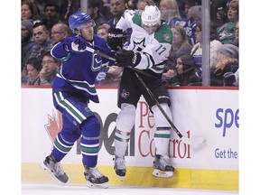 Dallas Stars' Devin Shore (17) is checked by Vancouver Canucks' Nikita Tryamkin (88) during third period NHL hockey action in Vancouver on Thursday, March 16, 2017.