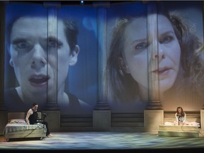 Damien Atkins (left) as Prior and Celine Stubel as Harper in Angels in America, Part One: Millennium Approaches, both on stage and via video cameras that project giant close-ups of them, a technique that puts the focus back onto the characters’ internal struggles.